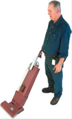 Man vaccuming - a man using a vacuum cleaner.