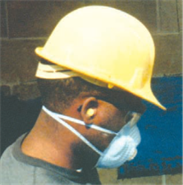Construction worker wearing a hard hat and a dust mask to work.